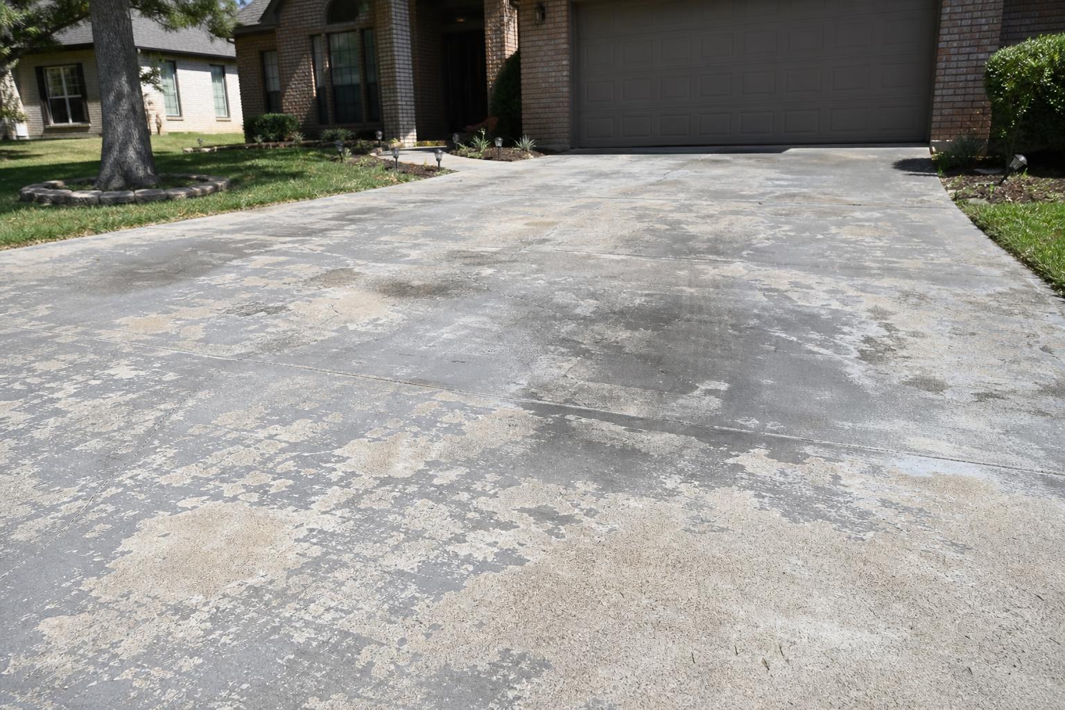 Painted concrete driveway stripped clean, before and after dustless blasting (before)